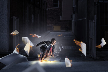 Wall Mural - Determined businessman leaving fire trails on asphalt