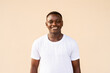 Portrait of handsome African man wearing white t-shirt while smiling