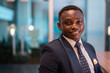 © Ranta Images - Portrait of handsome African businessman smiling at night