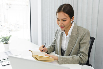 Confidence woman concept, Businesswoman taking note information on notebook while video conference