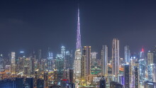 Panoramic Skyline Of Dubai With Business Bay And Downtown District Night Timelapse.