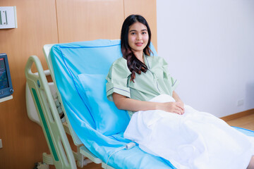 Happy smile successful Beautiful woman patient triumphing in modern hospital room EKG Monitor, success happy pose. Clean room with a bed in the new medical center