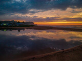 Fototapeta Niebo - Dawn reflections and clouds at the seaside with lagoon
