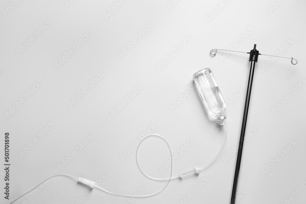 Infusion Set Background IV infusion set on light grey background, flat lay. Space for text ...