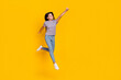 © deagreez - Full size photo of young cheerful girl jump fly power look empty space isolated over yellow color background
