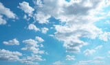 Fototapeta Na sufit - Beautiful natural skies background.  Panorama of blue sky with clouds and sun hidden behind them.  Meteorology theme, atmosphere concept, weather theme.