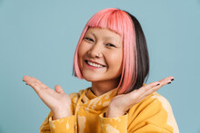 Asian Girl With Pink Hair Smiling And Holding Copyspace