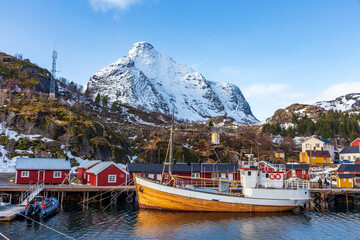 Nusfjord  Norway. 07-03-2022. Wooden Fishing boat  and colored houses at Nusfjord  harbor.