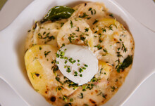 French Brunch Of Tartiflette With A Poached Egg, Potatoes And Chives