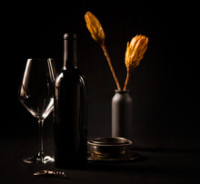Red Wine Bottle With Empty Glass On Dark Background