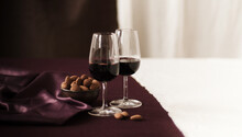 Two Glasses Of Port With Chocolate Covered Almonds