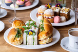 Fototapeta Tulipany - Traditional english afternoon tea with selection of cakes and sandwiches