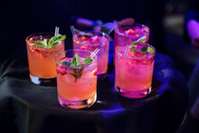 Tray Of Raspberry, Mint, Vodka Cocktails Being Served At An Event.