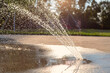 Leinwandbild Motiv Park with splashing water fountain. Splash pad on a sunny summer day.