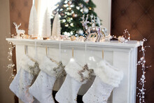 White Christmas Socks Hanging On Fireplace