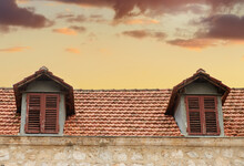 Red Tiled Rooftop Of An Old House Of Trebinje, Bosnia And Herzegovina On The Background Of Sunset Sky.