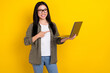 Photo of nice young brunette lady index laptop wear eyewear khaki shirt isolated on yellow color background