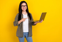 Photo Of Nice Young Brunette Lady Index Laptop Wear Eyewear Khaki Shirt Isolated On Yellow Color Background
