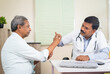 © WESTOCK - Senior patient consulting doctor at hospital for health problem - concept of professional