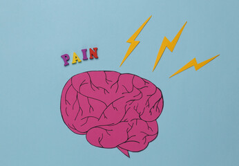 headache. paper-cut brain and thunderstorm with the inscription pain on a blue background