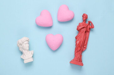 Wall Mural - Love, romantic concept. Antique busts with hearts on a blue background