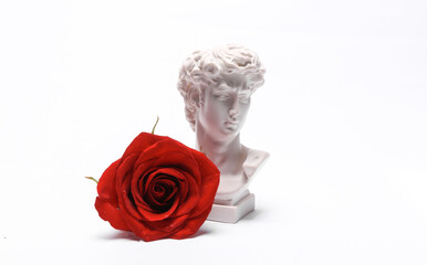 Wall Mural - Aesthetic still life, David bust with red rose flower isolated on a white background. Romantic, love concept