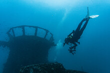 Diver Exploring The Wreck Of The HTMS Sattakut In Thailand