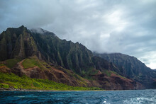The Gorgeous Rugged Wilderness And Cliffs Of Kauai's Napali Coast In Hawaii, With Low Clouds And Mist Hanging Over The Mountain Peaks Under A Stormy Grey Sky