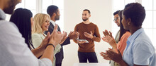 Business Team Clapping Hands After A Speaker's Presentation In A Corporate Meeting. Group Of Happy Mixed Race People Stand Up And Applaud Their Colleague Thanking Him For His Report