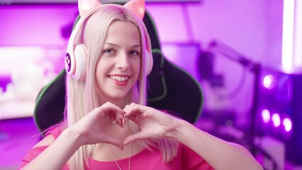 Poster - Cute blonde gamer girl with cat ear headphones in cyberspace show love sign 4K