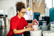 © Dusan Petkovic - A printing shop employee choosing right color from bucket for printing machine.