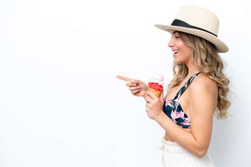 Wall Mural - Girl wearing a swimsuit and holding cornet ice cream isolated on white background pointing to the side to present a product