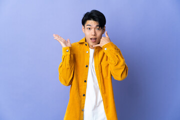 Wall Mural - Young Chinese man isolated on purple background making phone gesture and doubting