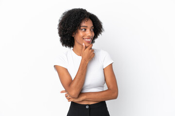 Wall Mural - Young African American woman isolated on white background looking to the side and smiling