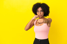 Young African American Woman Isolated On Yellow Background With Fighting Gesture