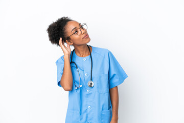 Young surgeon African American doctor woman isolated on white background thinking an idea