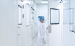 Unidentified microbiologist is open the cleanroom door to enter the room in clean area of microbial laboratory in pharmaceutical factory, concept of science, healthcare and safety operation.