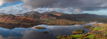 Beautiful Landscape Autumn Image Of View From Walla Crag In Lake District, Over Derwentwater Looking Towards Catbells And Distant Mountains With Stunning Fall Colors And Light