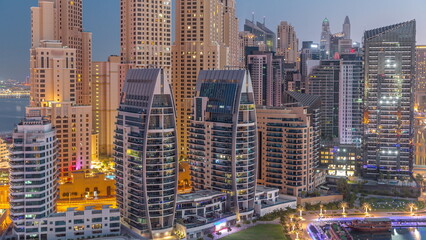 Dubai Marina skyscrapers and JBR district with luxury buildings and resorts aerial night to day timelapse