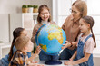 © JenkoAtaman - Teacher and kids during geography lesson