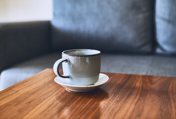 Wall Mural - Cup of coffee on a wooden table. Copy space