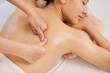 © DragonImages - Masseur giving deep tissue back massage to young female client