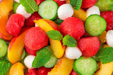 Wall Mural - Healthy summer fruit salad with watermelon, peach, mozzarella cheese, cucumber and mint. close up