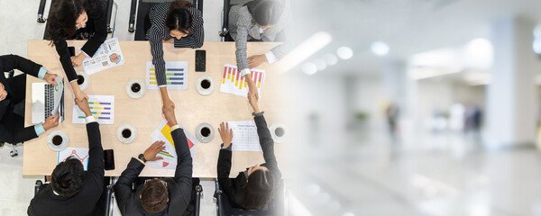 Wall Mural - Group business people handshake at meeting table in office together with confident shot from top view . Young businessman and businesswoman workers express agreement of investment deal. broaden view