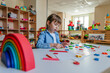 © lithiumphoto - Little girl playing with letters at kindergarten