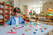 © lithiumphoto - Little girl writing and playing with letters at kindergarten