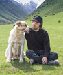 © Chepko Danil - Alabai breed dog with a young guy on the background of the Alpine mountains, a pet friendship with a man