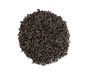 Dry black tea leaves heap in a round on white isolated background
