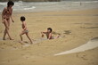 © Xan Gasalla - two brothers play at splashing their mother with water on a Galician beach
