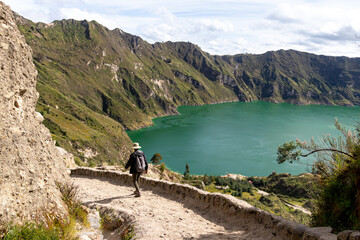 Wall Mural - Lake Quilotoa in caldera of eponymous volcano.  Hiking patch and tourist on the way down to the lake. Cotopaxi province, Ecuador